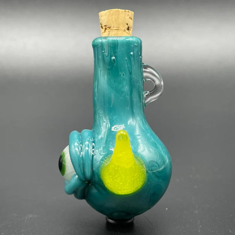 Close-up of Agua azule cyclops potion bottle - handcrafted glass