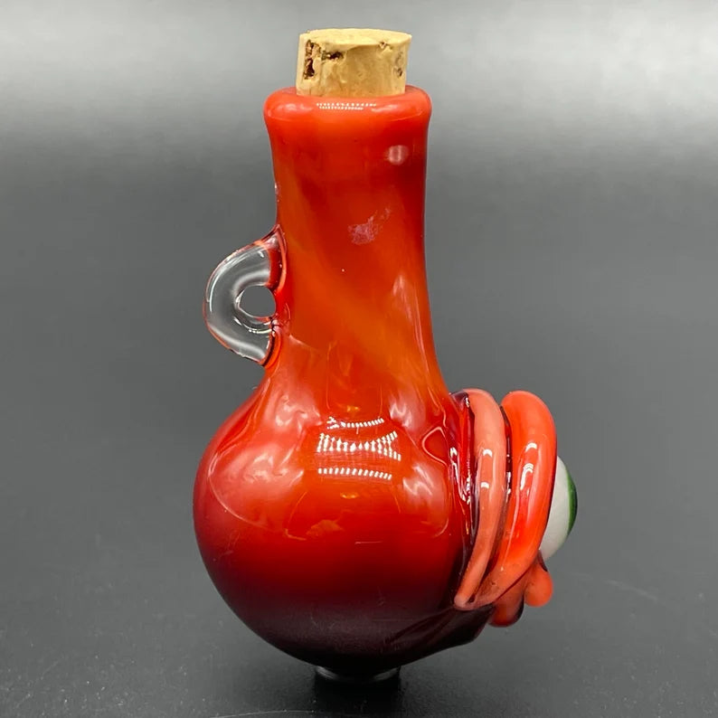 Close-up of Red over white cyclops potion bottle - handcrafted glass