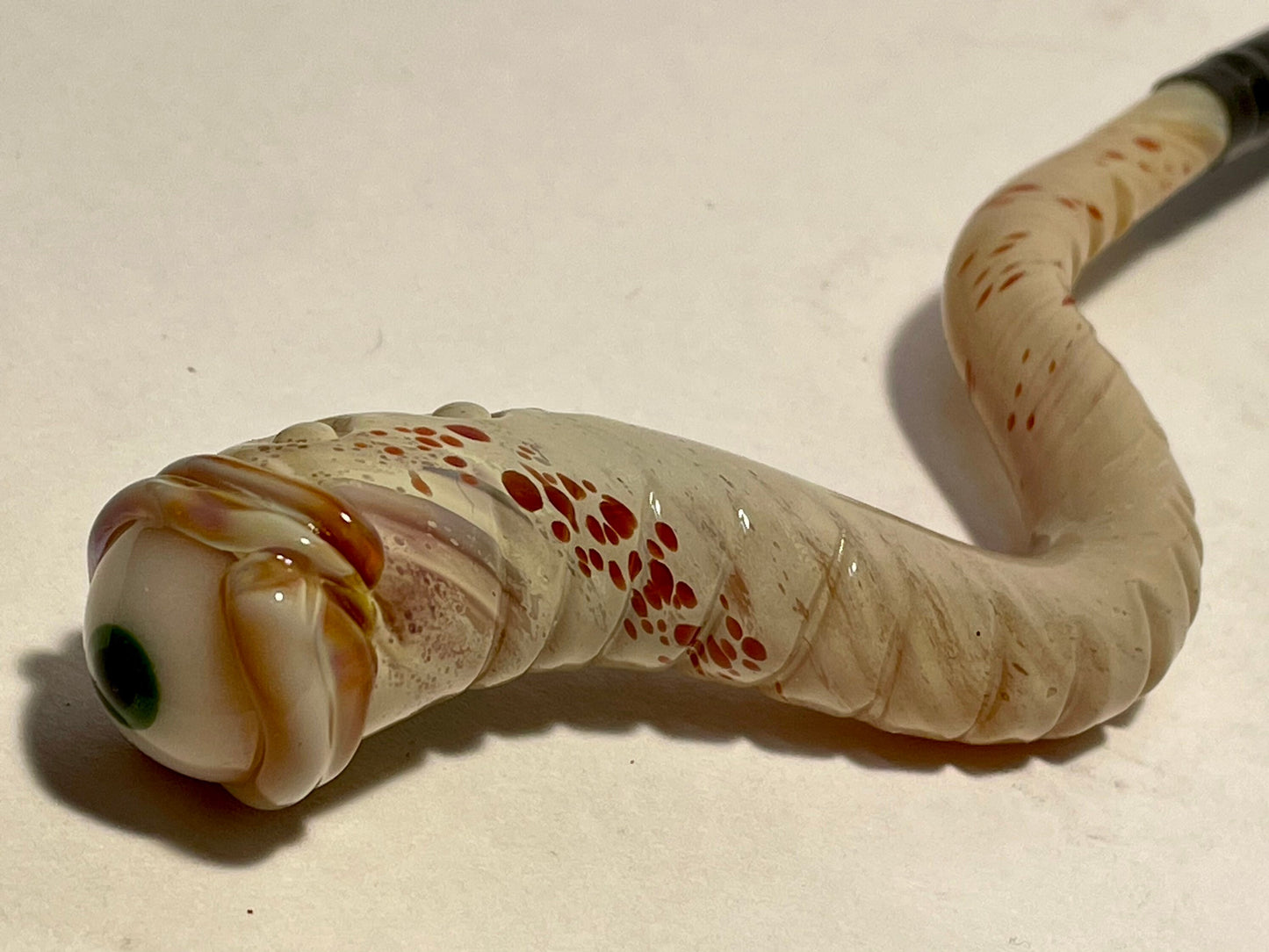 Glass makeup brush with glow in the dark eye and carved ventral scales. by Leviathan Glass - artisan detail