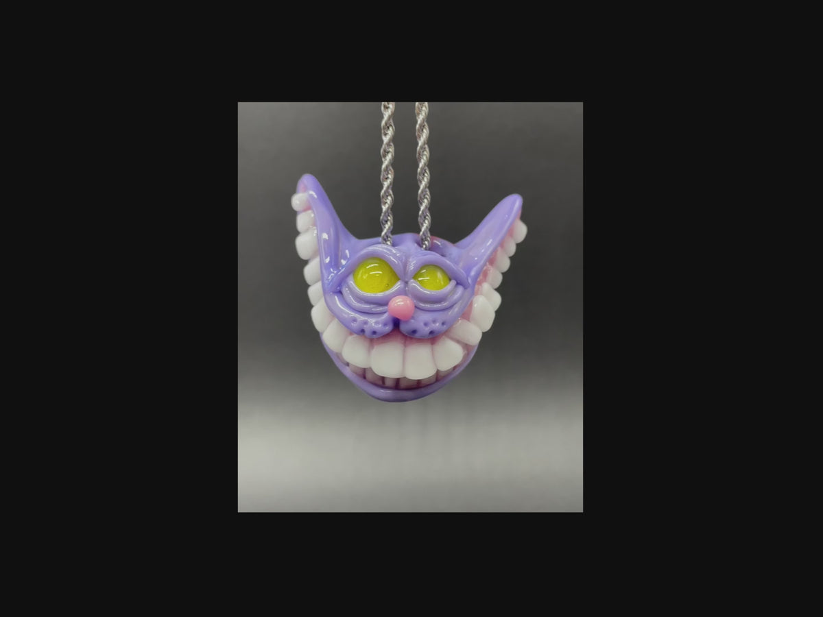 Load video: Purple Cheshire with HUGE Teeth pendant from Leviathan Glass
